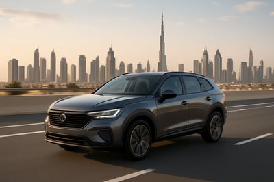 Modern vehicle driving on a Dubai road with city skyline in the background